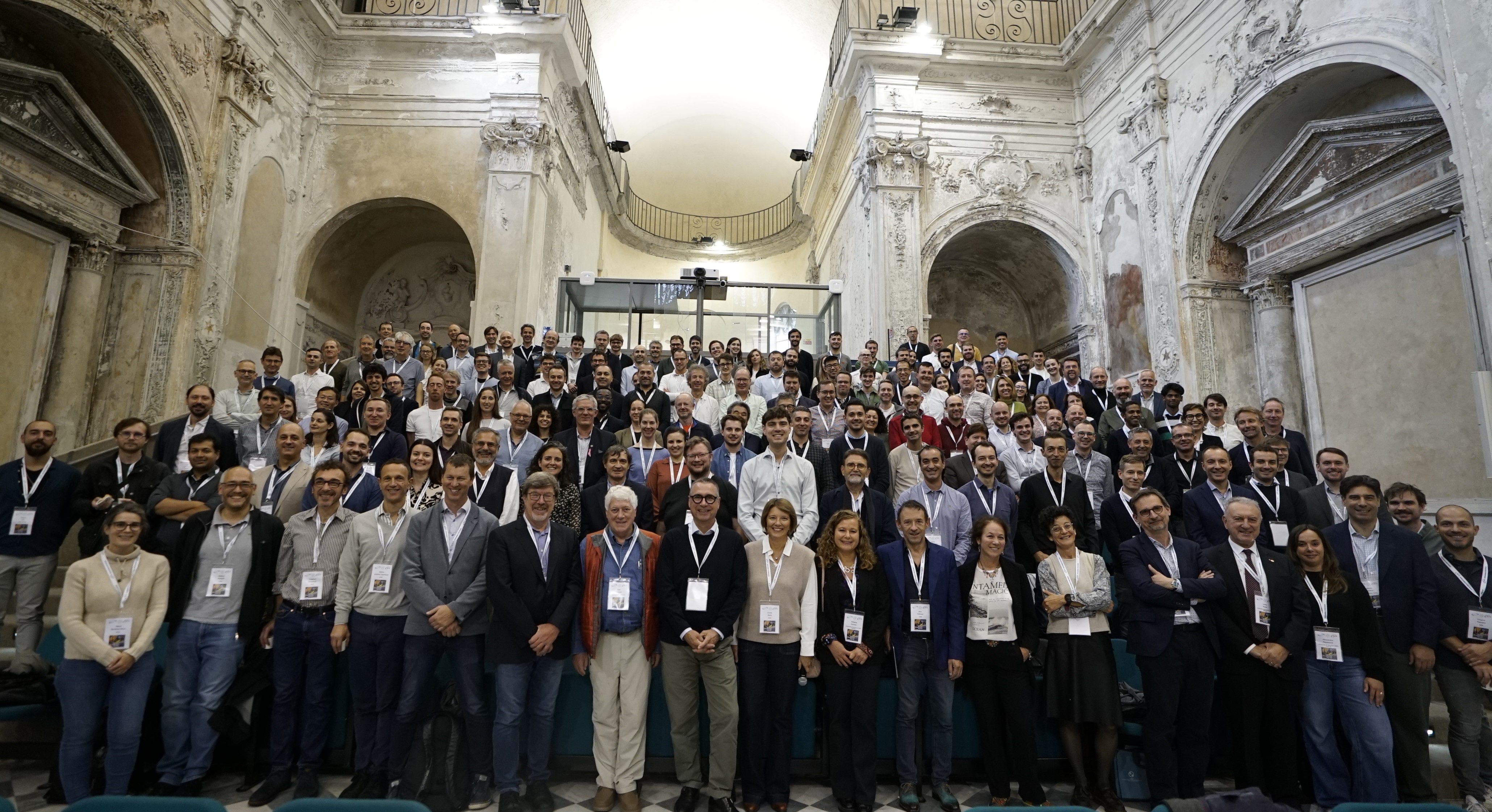 group picture of participants of Genoa meeting in a former church building