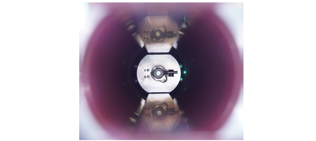 Photograph of the laser treatment assembly during processing – inchworm mole (developed in collaboration with the University of Dundee) in an 80 mm diameter LSS test chamber with Al inserts on top and bottom and laser spot focussed to and scanned across the vacuum chamber inner surface.