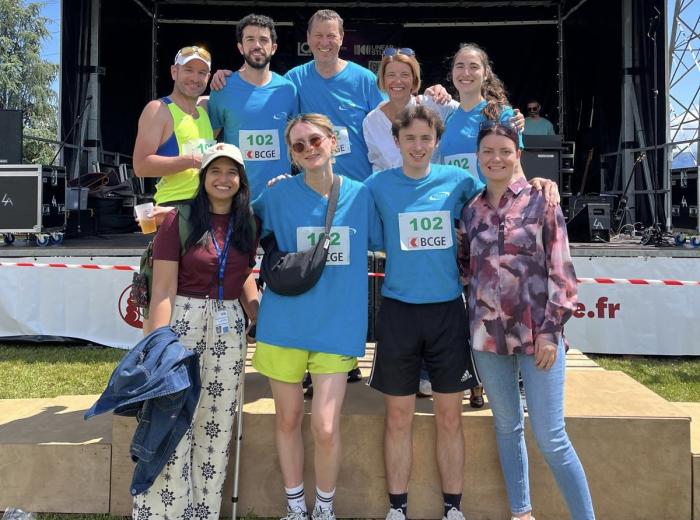 running team and others on a podium